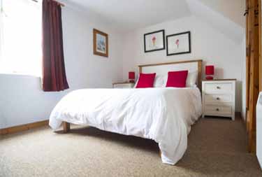 Bedroom interior view at Abbey Place cottage in Mousehole, Cornwall